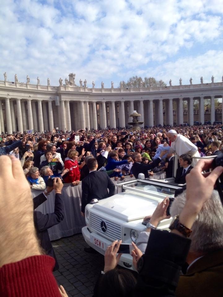 Pope Francis stopping before the Papal Audience to kiss some babies.