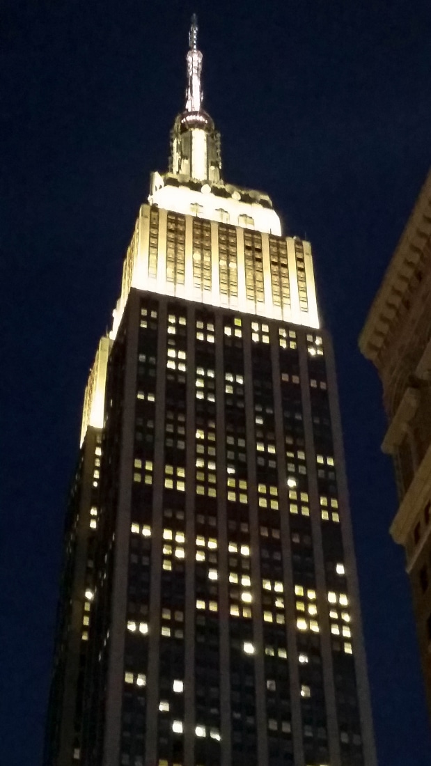The top of The Empire State Building at night.