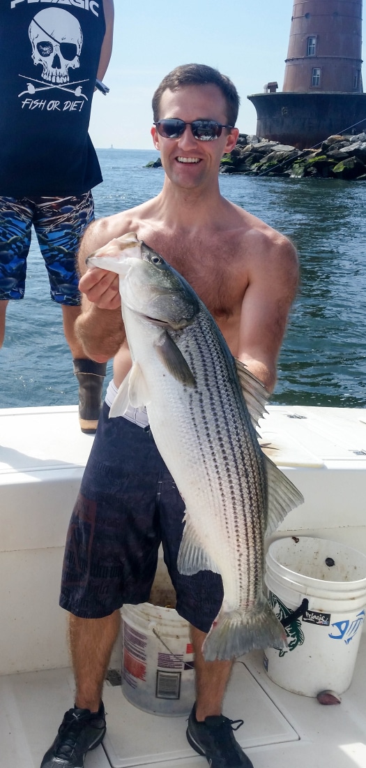 My husband with his 33' 16 lb striped bass.