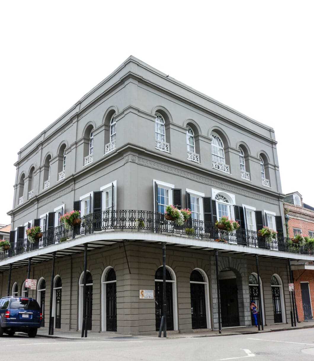 Madame Delphine LaLaurie's house in day light, a grey 3 story home on a corner in New Orleans 
