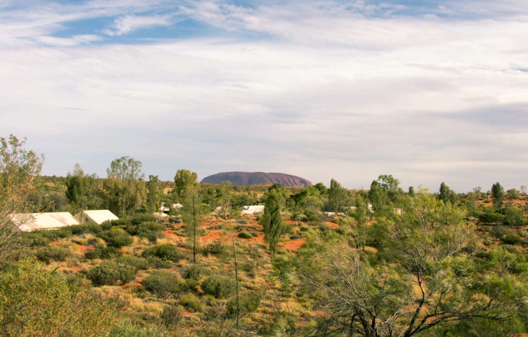 View of Uluru from distance and cloudy sky