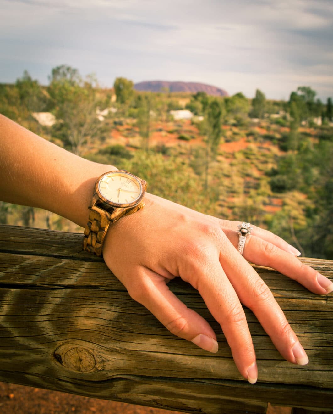 hand of a women wearing Jord watches and  a beautiful diamond ring 