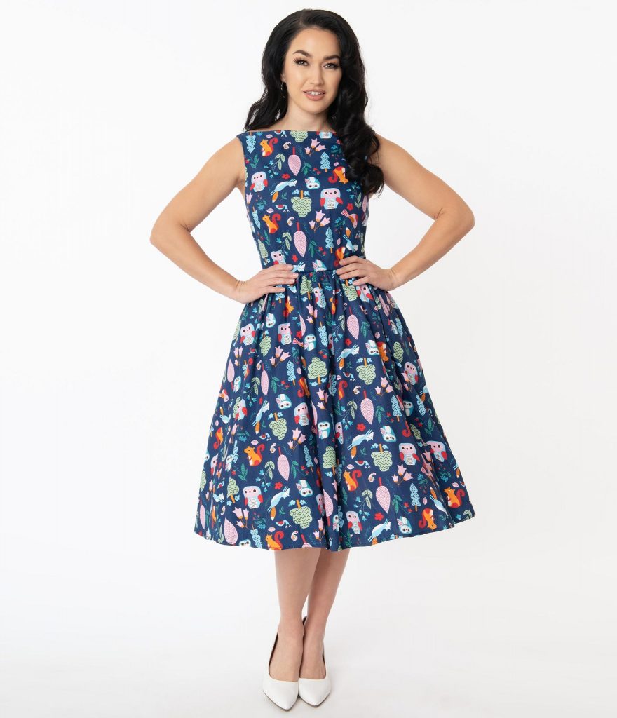 Unique Vintage Blue Forest Animal Print Lacey Swing Dress paired with white heels against a white background