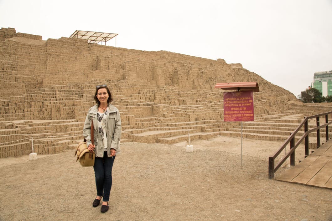 A women standing in front of pre-Incan ruins in Lima.