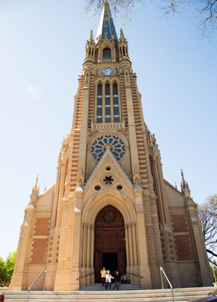 A vertical view of the San Isidro Cathedral against a clear blue sky