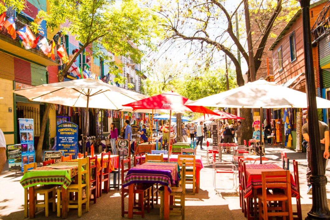 Colorful tables and chairs on a street in La Boca, Argentina.