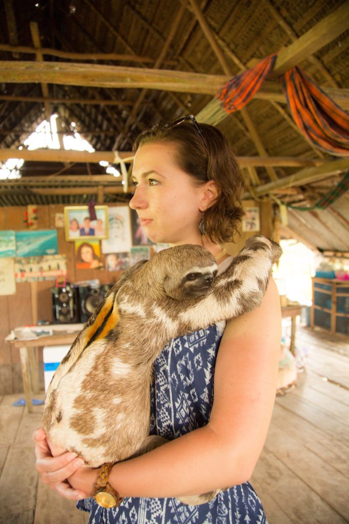 Me with the cute sloth in a village in Amazon 