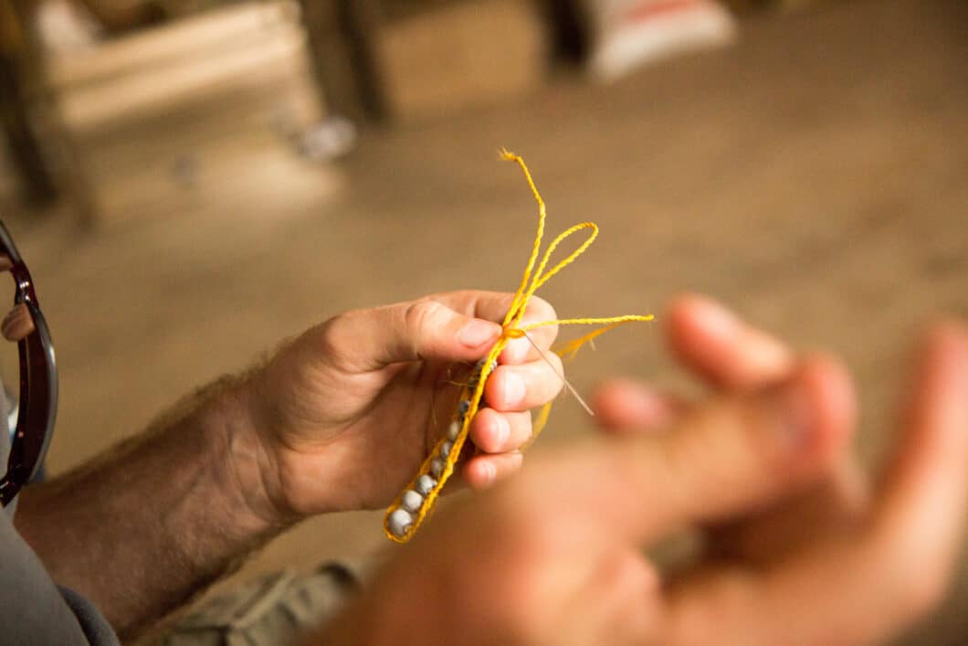 My husband is making a bracelet for me in our visiting in a village in Amazon 