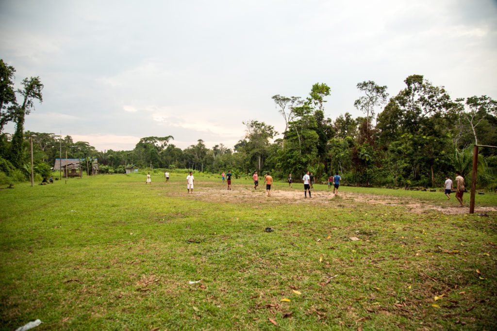 The kids were playing soccer in a village in Amazon 