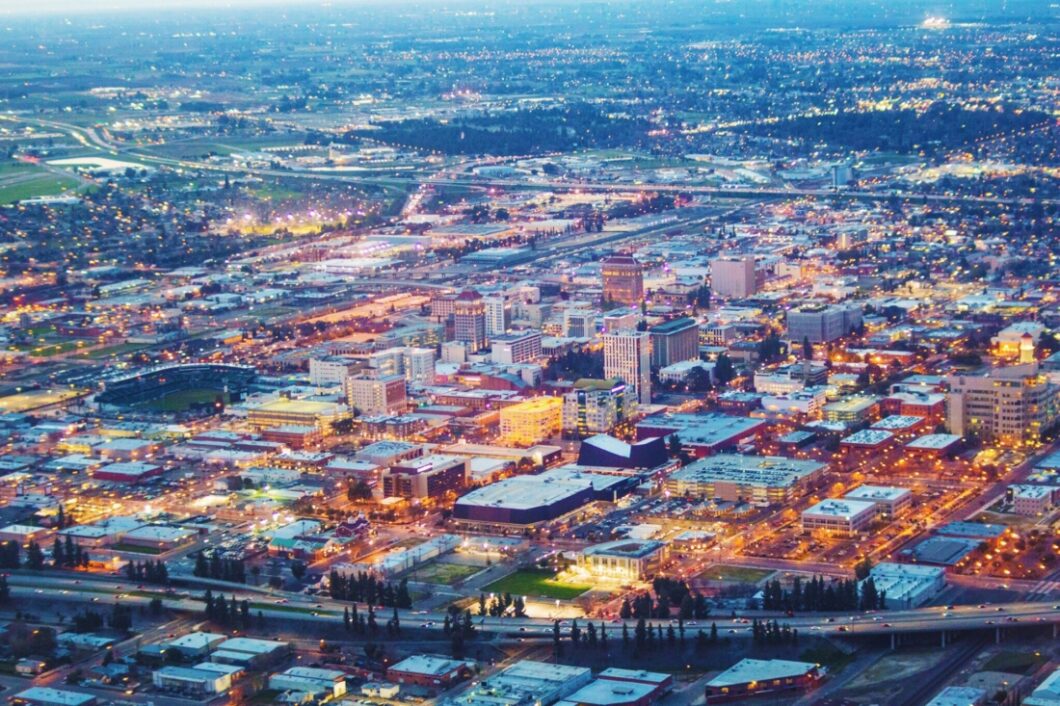 A skyline view of the city of Fresno, California at dusk.