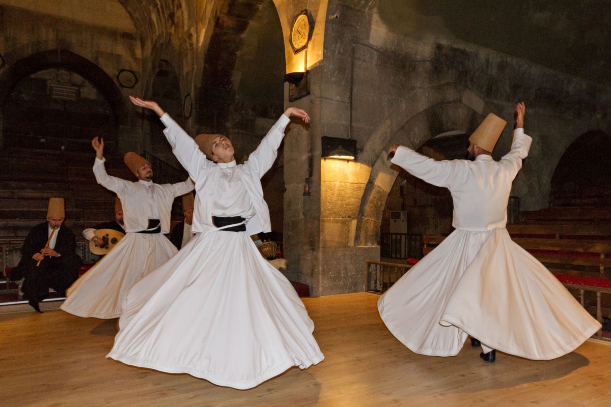 NEVSEHIR, TURKEY - MAY 17, 2015: Whirling dervishes perform in an old caravansary in Nevsehir, Turkey.