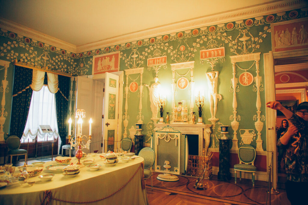 Another angle of an elegant private dining room inside Catherine Palace, showing walls covered with intricate crown molding.