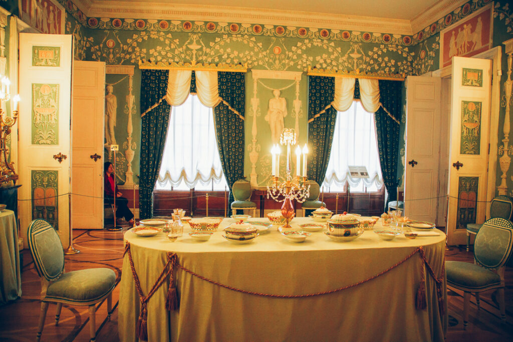 the interior of a dining room at Catherine Palace with a table set for two with fine china.