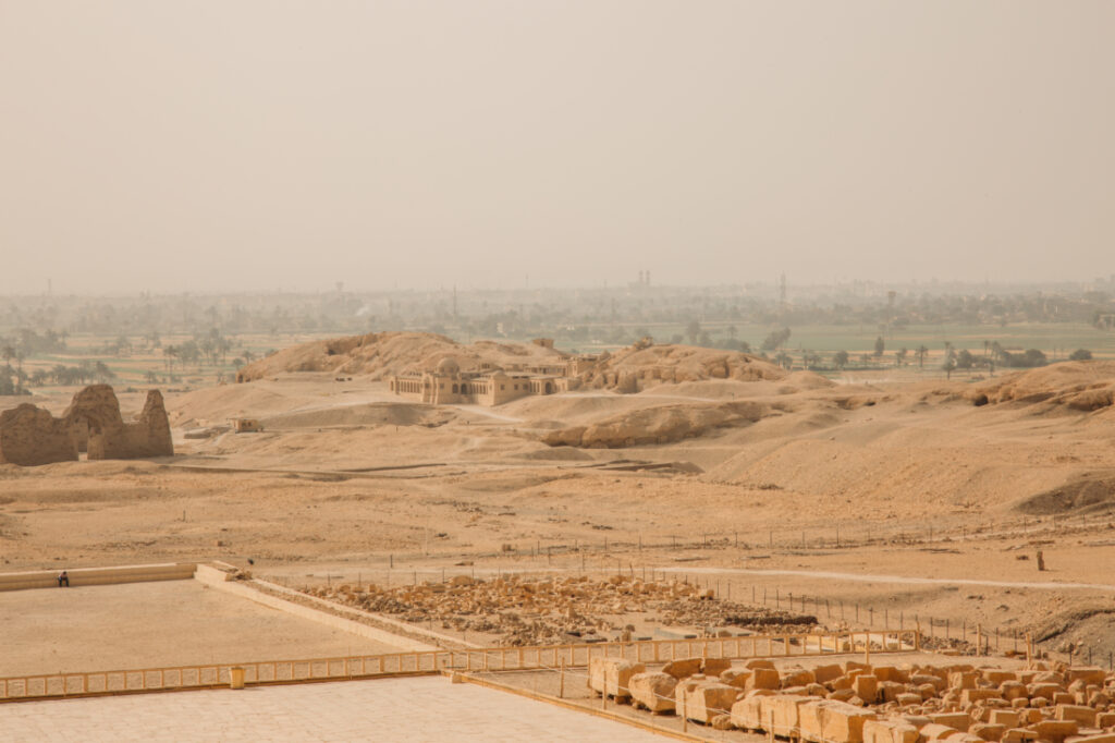 An image shows the expansive landscape looking out across the desert from the Temple of Hatshepsut. 