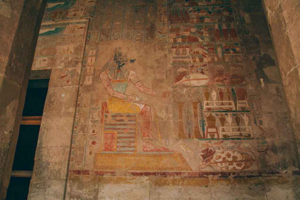 The inside walls of the Temple of Hatshepsut are covered in ancient Egyptian carvings that still have color to them.