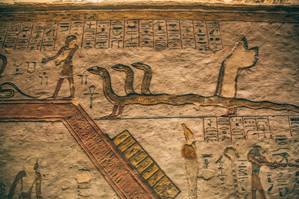 Ancient carved artwork lines the stone walls deep inside a Valley of the Kings tombs.