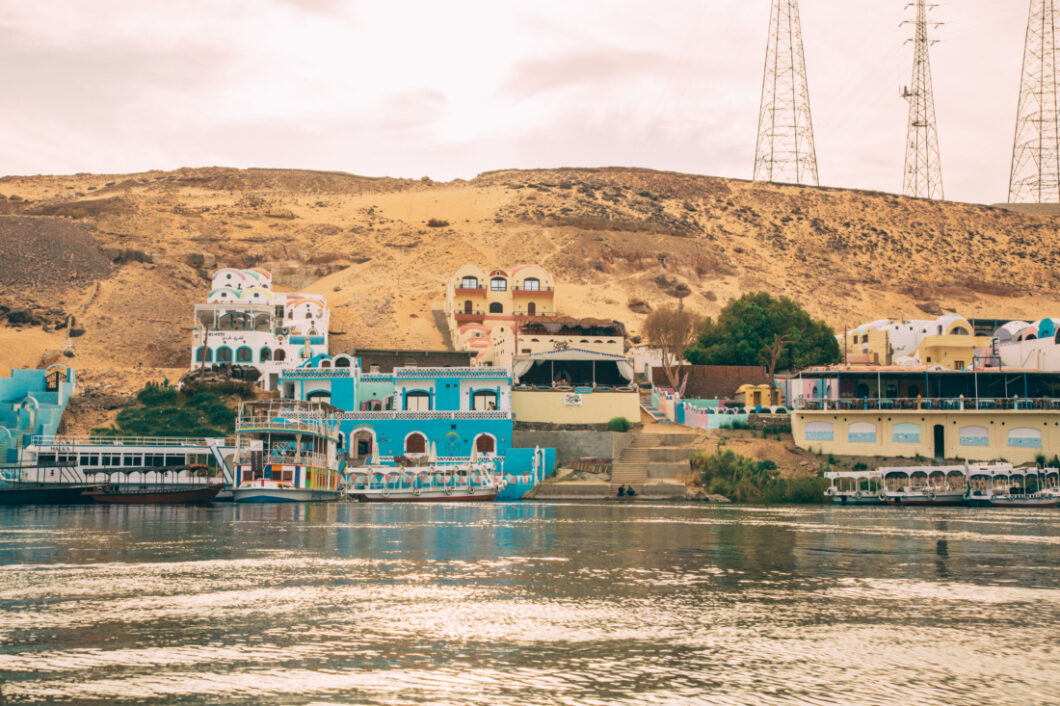 Buildings and homes line the riverbank in the Nubian Village along the Nile River.