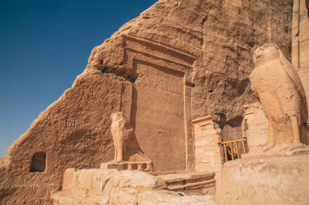 An image of giant animal statues outside the main entrance of one of the Abu Simbel temples.