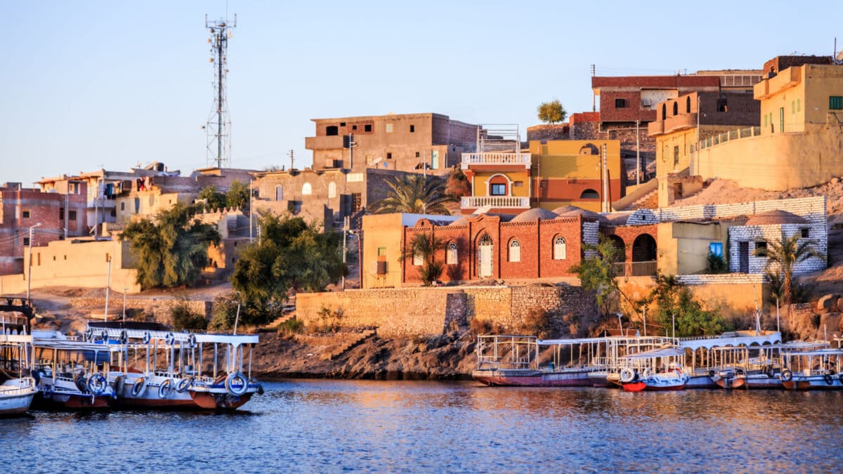 Wooden boats carrying passengers docked along the Nile River at the Temple of Philae in Aswan, Egypt, North Africa