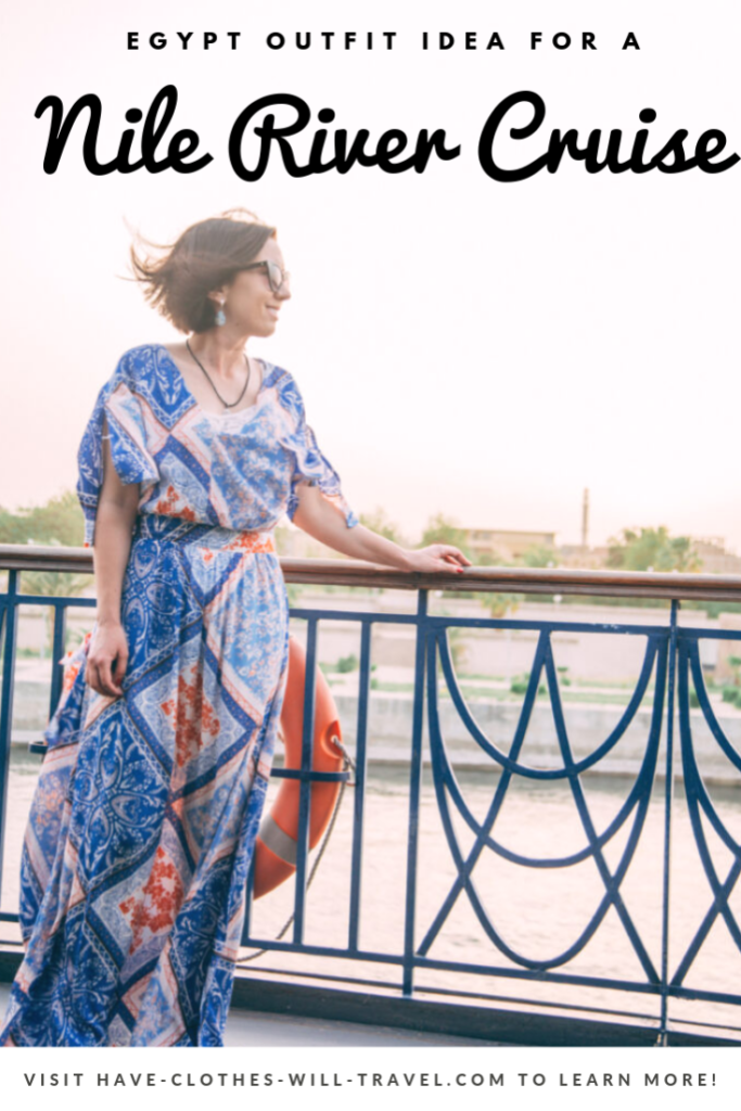 A woman poses on the deck of a cruise ship, looking out at the scenery. She's wearing a blue and orange patterned maxi dress. Text on the image reads "Egypt Outfit for a Nile River Cruise"