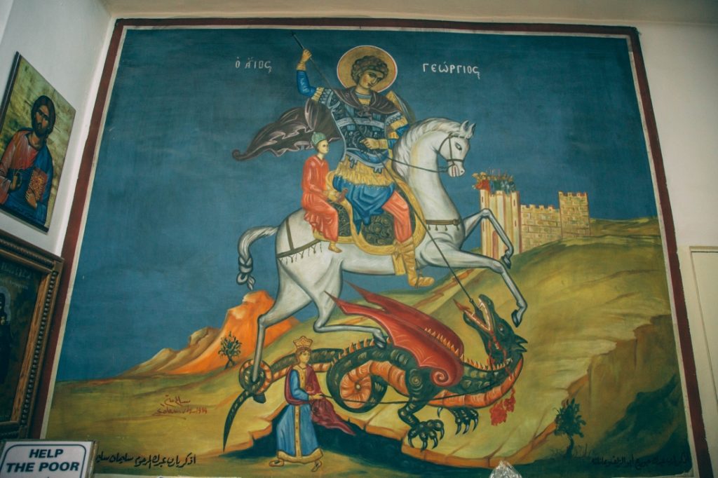 A painting of jesus on a horse and a dragon in St. George church.