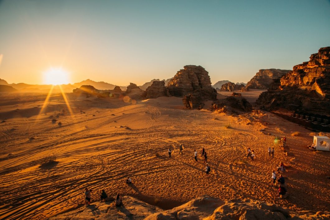 People watching the sunset in a desert at Mazayen Rum Camp in Jordan