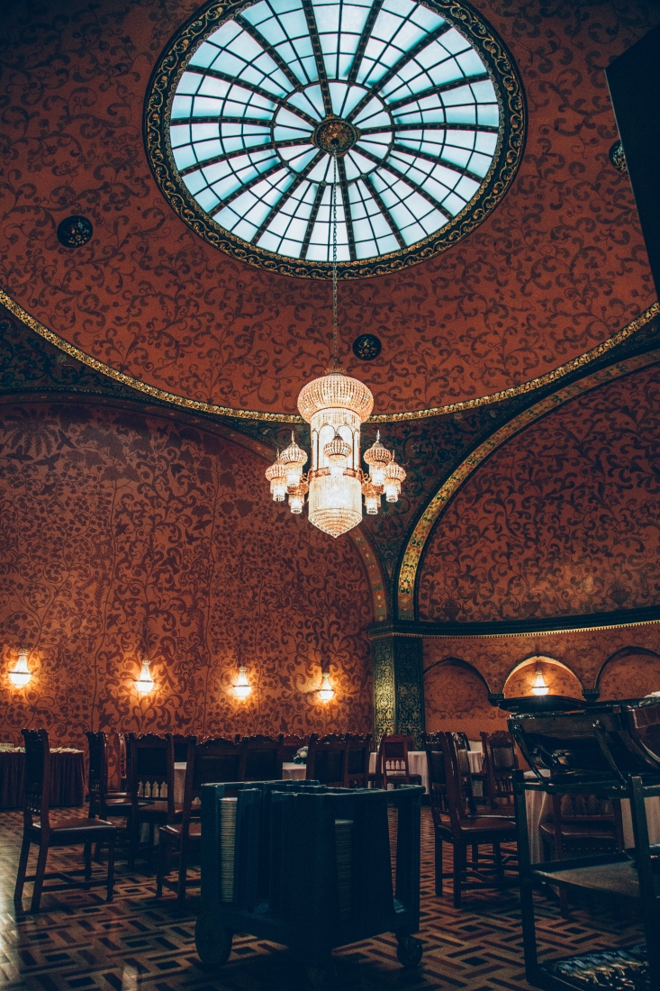 A look up at the tall vaulted ceilings and glass obelisk inside the fictional Boyarsky Restaurant at Metropol Hotel.