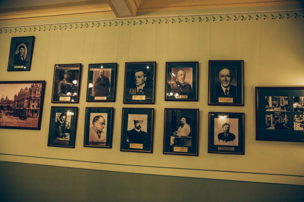 Old framed photos of famous guests that have stayed at the Metropol Hotel in Moscow, Russia.