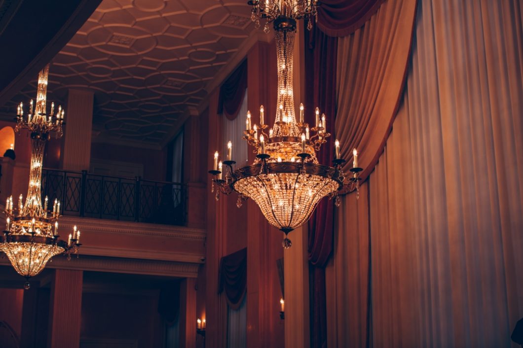 Gorgeous crystal chandeliers hang from ceiling inside the Bolshoi theater in Moscow, Russia.