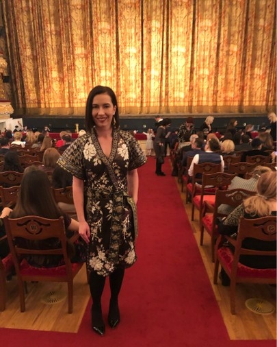 A woman poses in the aisle of the Historic Theater inside the Bolshoi Theater in Moscow, Russia.