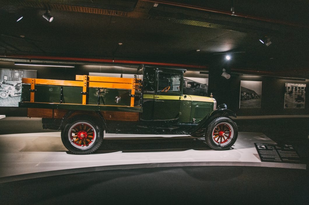 A 1927 Chevrolet Series AA Capitol, also called a Chevrolet Capitol. The vintage pickup truck style care is green with a lighter strip down the carriage, and wooden siding on the bed of the truck.