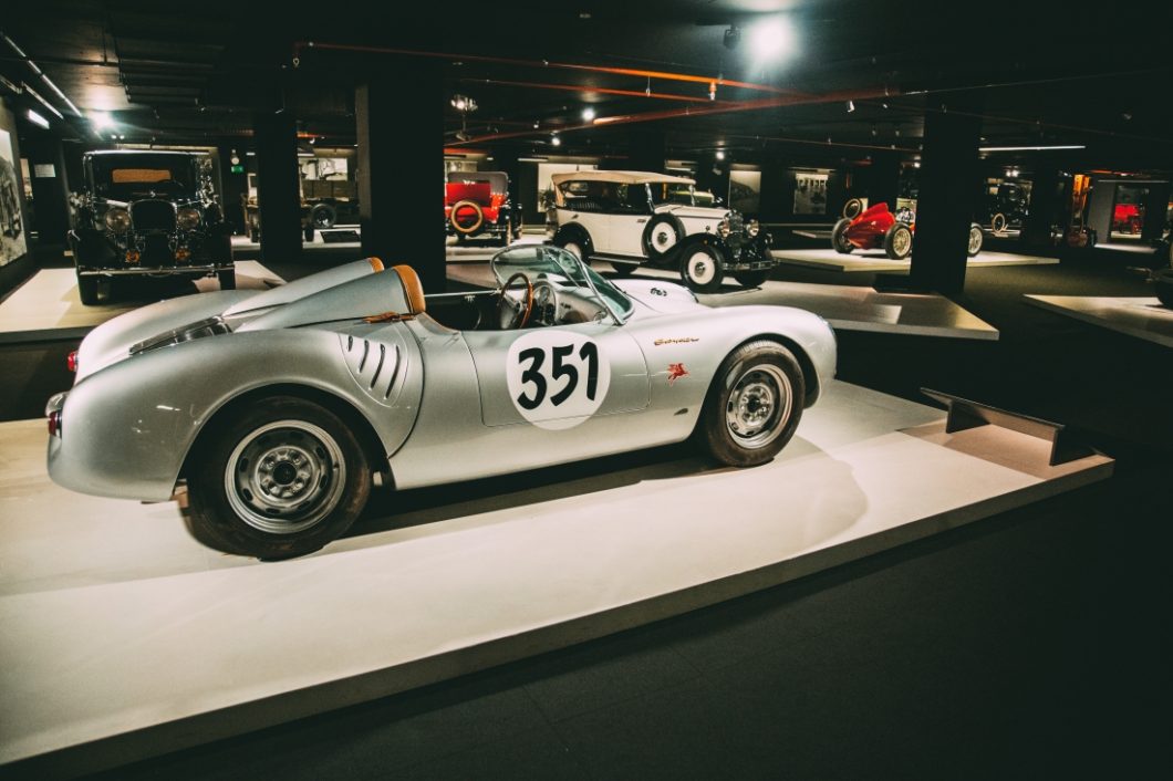 An all-silver Porsche 550 Spyder with a large 351 decal on the side, on display at the Heydar Aliyev Center's Classic Car Exhibit in Baku, Azerbaijan.