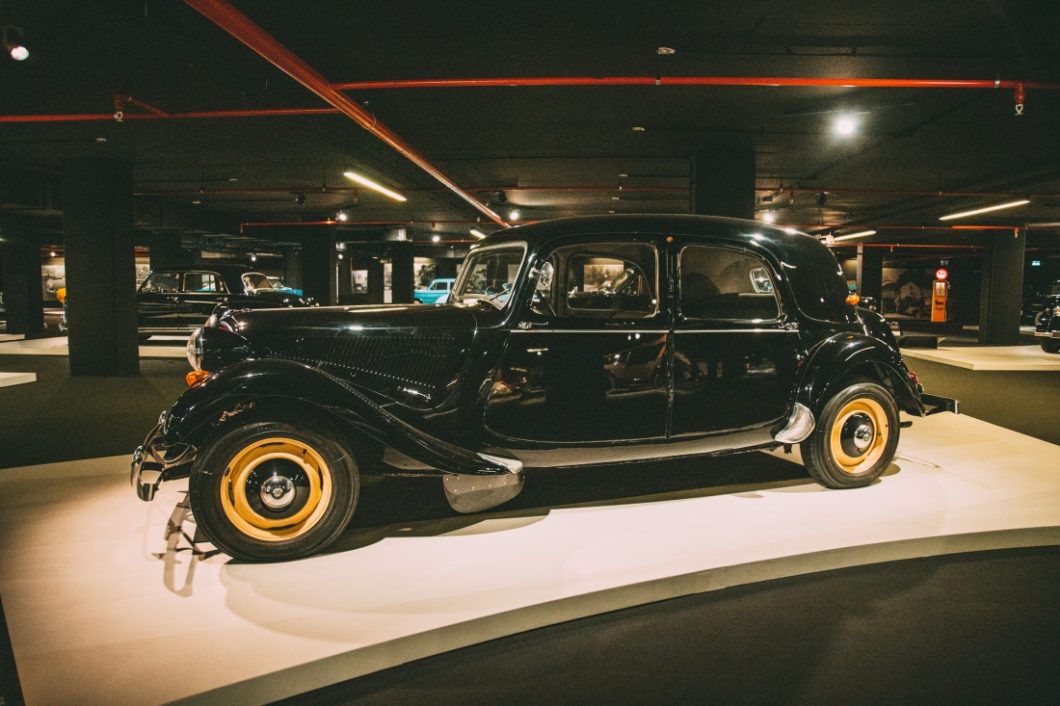 An all-black vintage 1950s style Citroen Traction Avant car on display in the Classic Car exhibit at the the Heydar Aliyev Center.