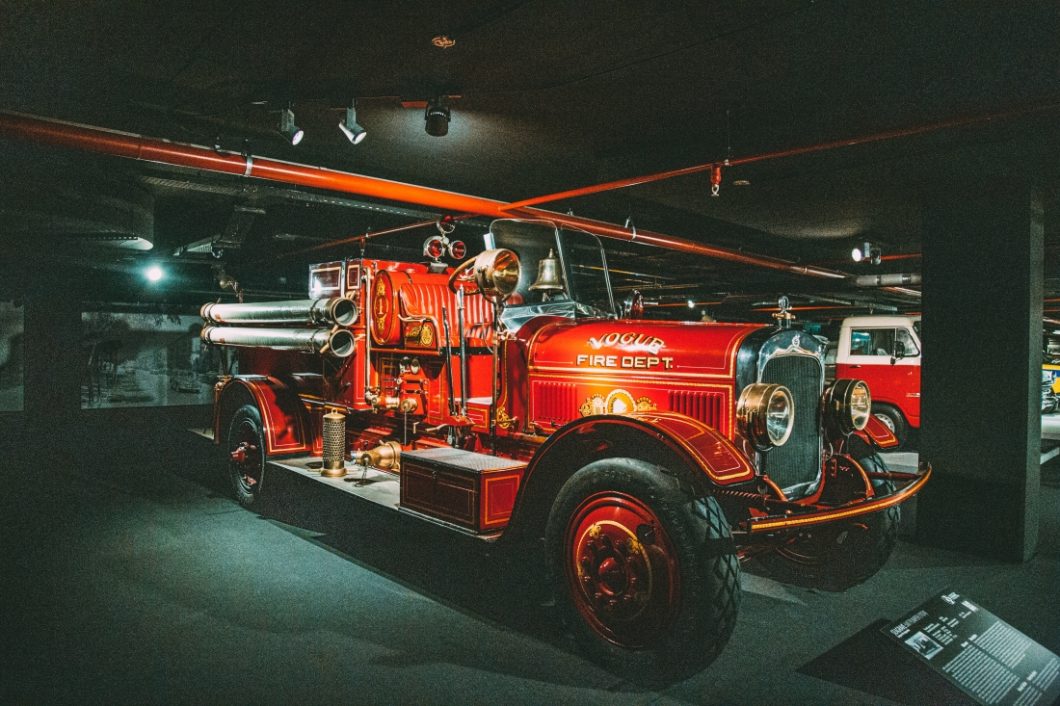 A vintage 1920 style Seagrave fire truck. The all-red truck is still displayed with vintage firefighting equipment and has a Vogur Fire Department decal on the hood.