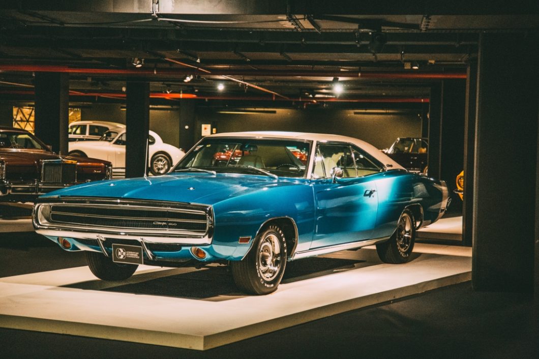 A classic 1970s Dodge Charger with an aqua blue body and crème white top on display at the Heydar Aliyev Center's Classic Car Exhibit in Baku, Azerbaijan