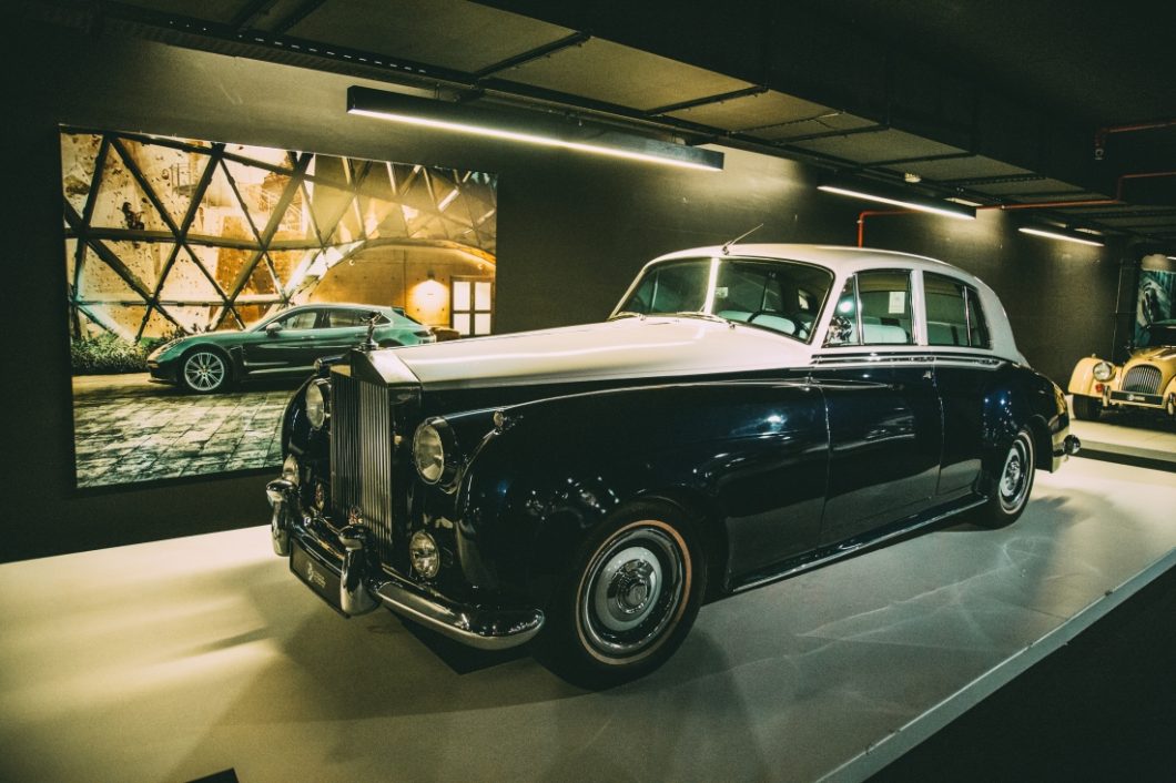 Another vintage Rolls-Royce Silver Cloud with an all-black body and white hood and roof, on display at the Classic Cars exhibit in the Heydar Aliyev Center in Baku.