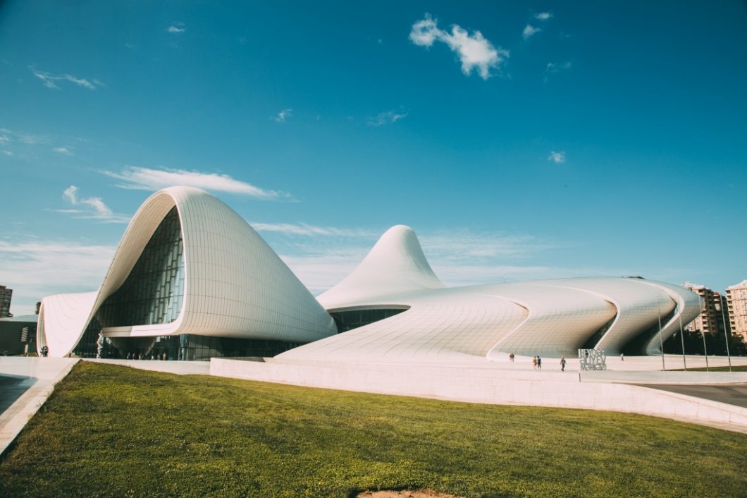 The Heydar Aliyev Center in Baku, Azerbaijan stands against a clear blue sky on a gorgeous day in Baku, Azerbaijan.
