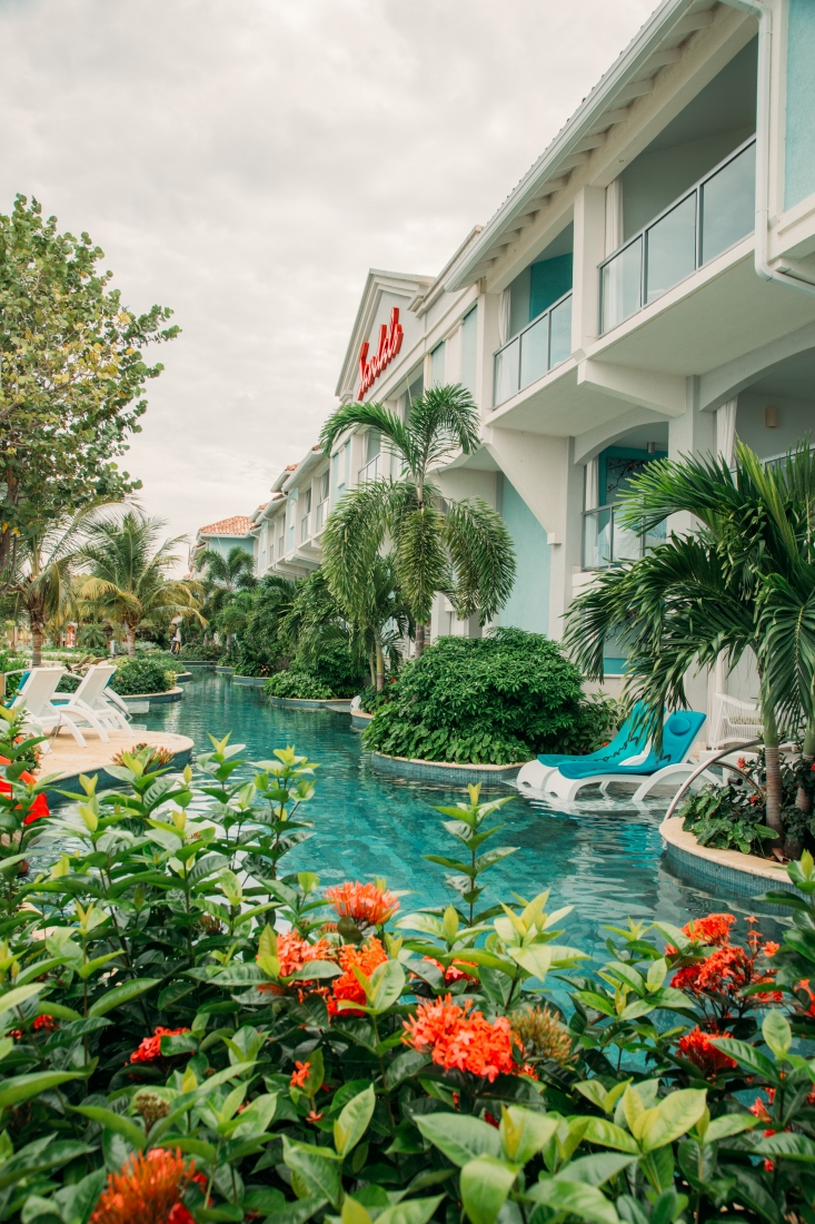 Swim up pool and lounge chairs outside the rooms at Sandals Montego Bay