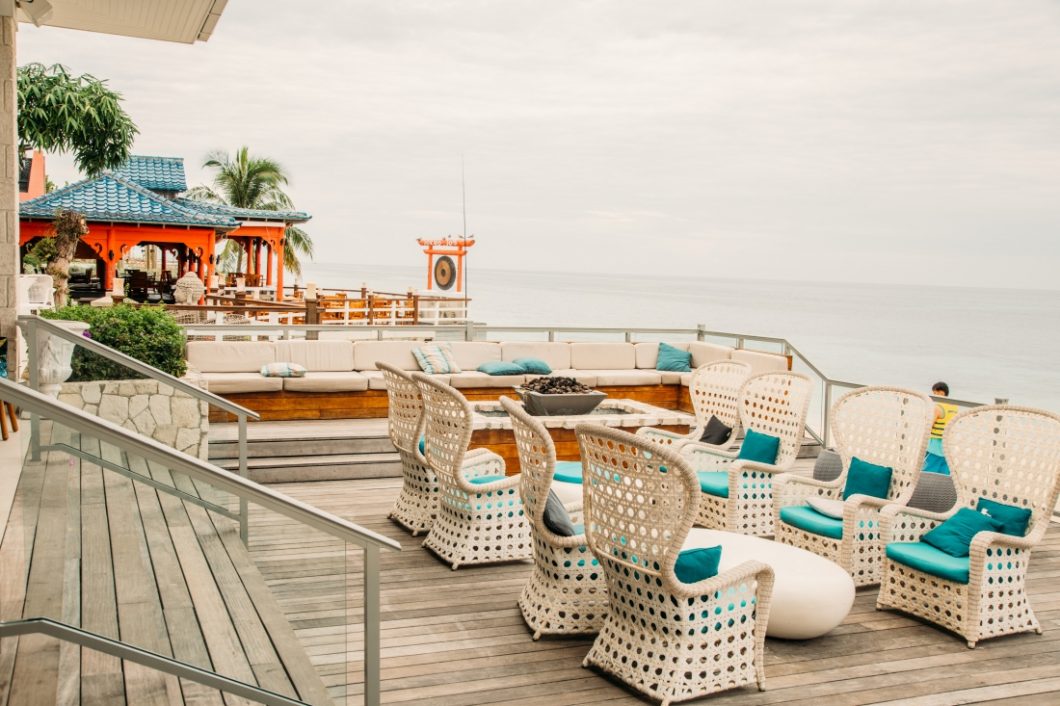 White wicker furniture and blue seat cushions on an over water deck at the resort