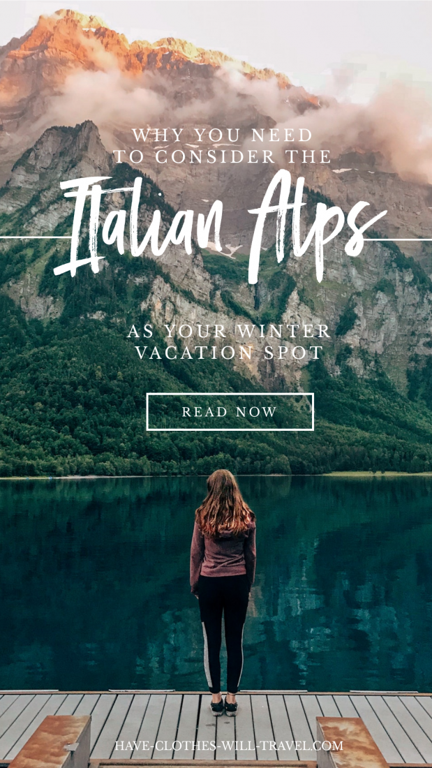 An idyllic image of a woman standing at the edge of a lake at the base of an Italian Alps mountain range. Text across the image reads "Why you need to consider the Italian Alps as your winter vacation spot"