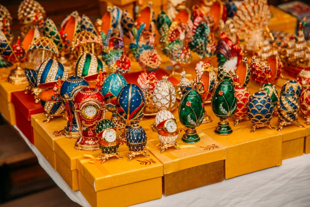 A display of replica Fabergé eggs of different sizes, styles, and colors.