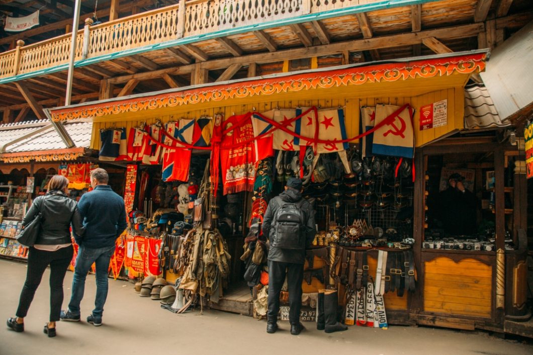 A Russians street vendor sells Soviet Union memorabilia, like flags, old street signs, and clothing. 