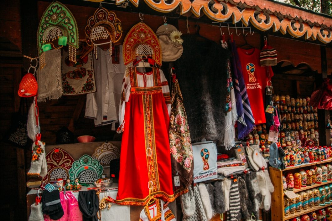 A street display of traditional Russian clothing, including robes and head dresses. 
