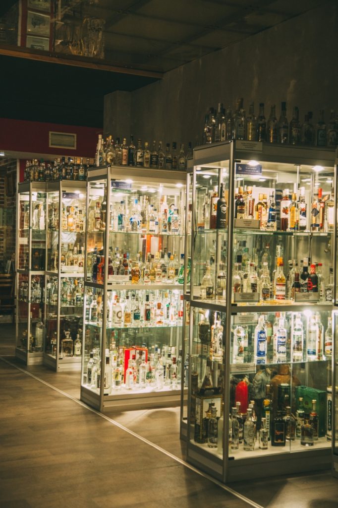 Glass shelves filled with vodka bottles at the vodka museum in Russia.