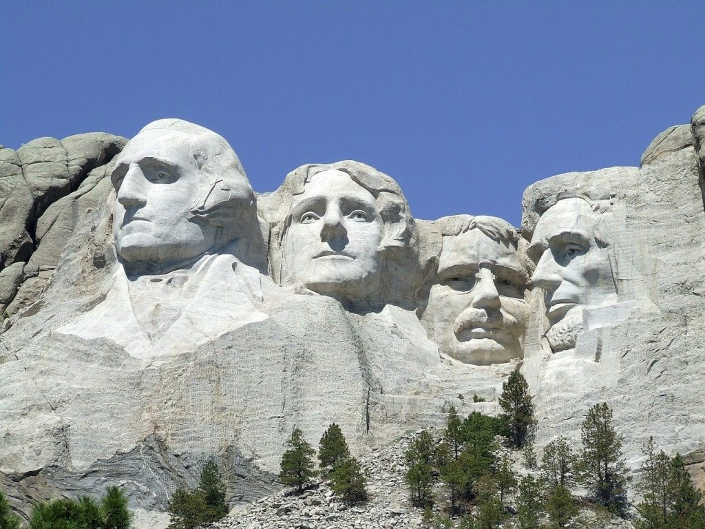 A professional photo of Mount Rushmore on a clear day against blue skies.