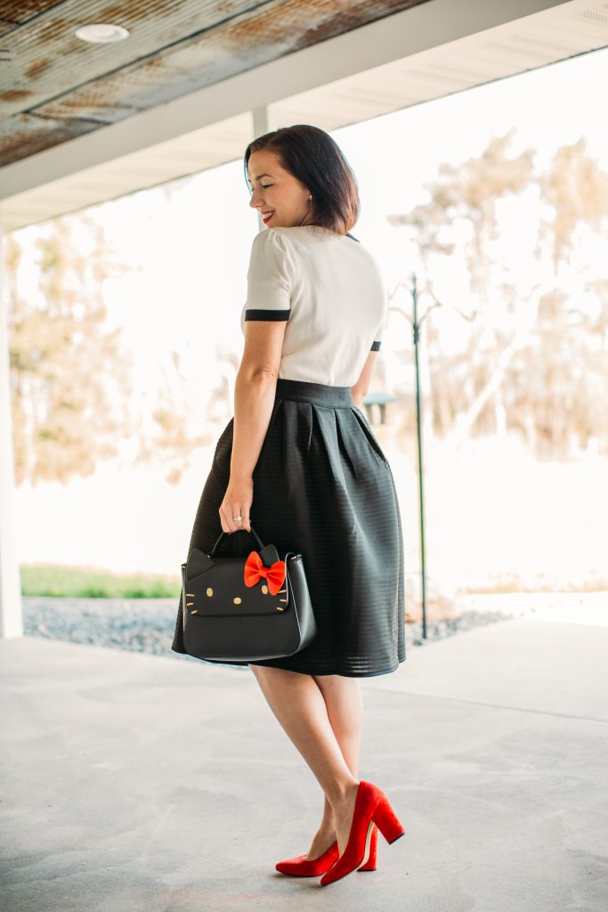 a black midi skirt by Pocket Passionista and Hello Kitty bag