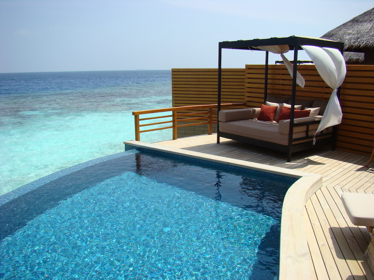 A private pool and lounge overlooking the ocean at baros maldives