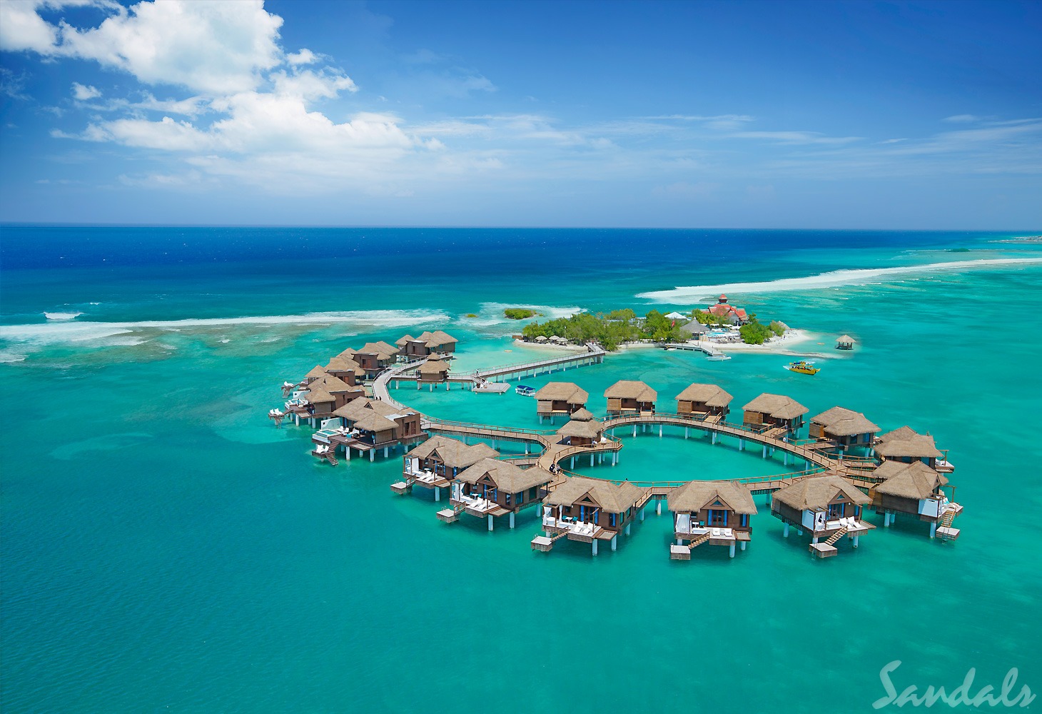 Photo from above of Sandals Royal Caribbean featuring overwater bungalows in the shape of a heart