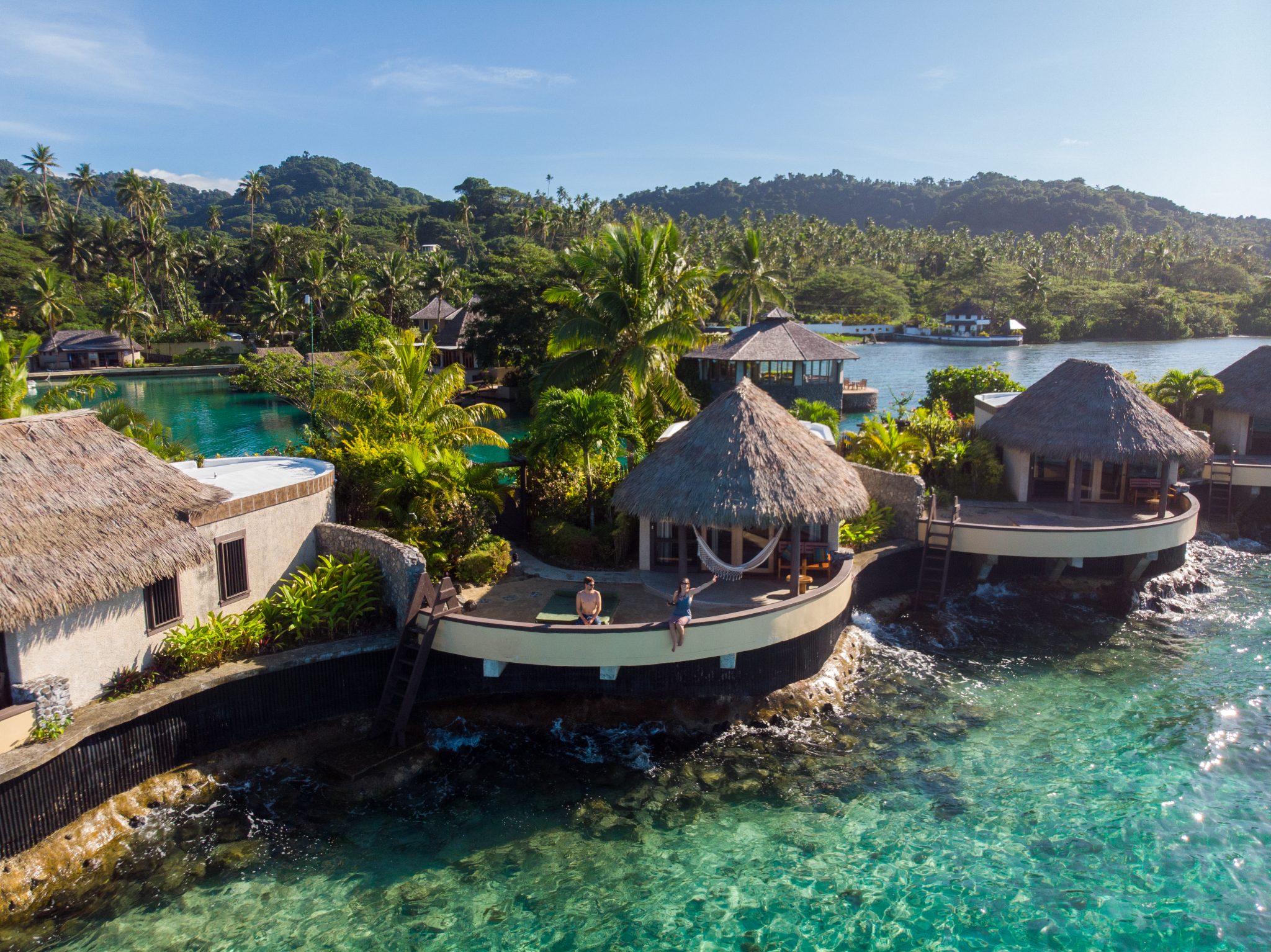 2 people on the balcony of their overwater bungalows at Koro Sun Resort and Spa, Fiji