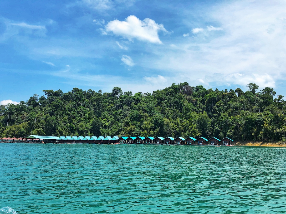 Smiley Bungalows, Khao Sok National Park - Thailand feaurting bright blue roofs against a clear blue sky